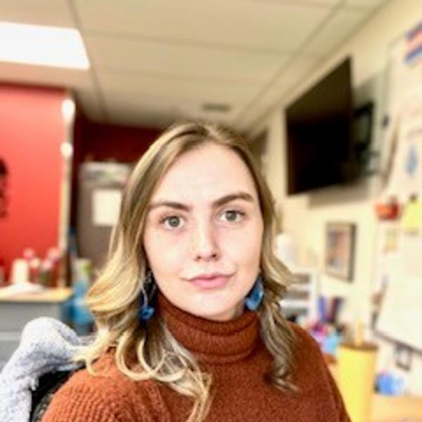 A young woman in a classroom. 