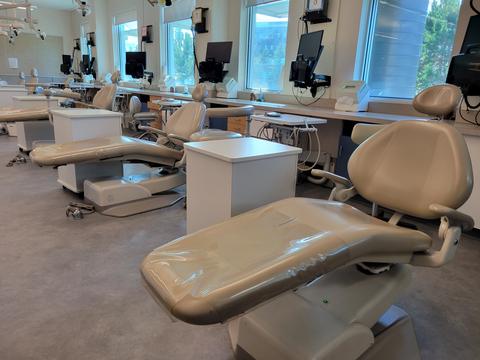 Dental chairs in line in dental clinic